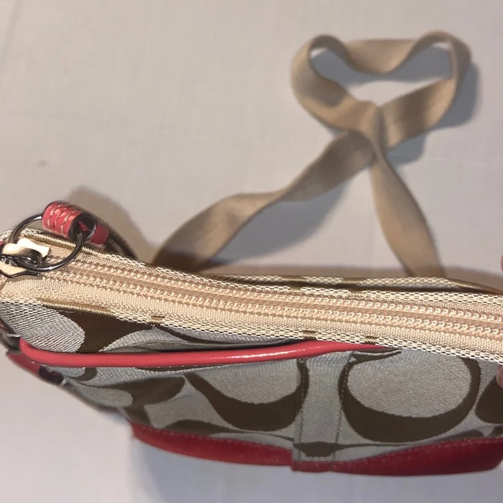 Tan and burnt orange Coach crossbody bag.